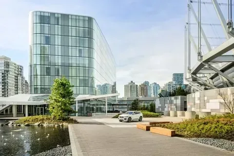 Glass tower entrance of JW Marriott Parq Vancouver beside a park, Vancouver